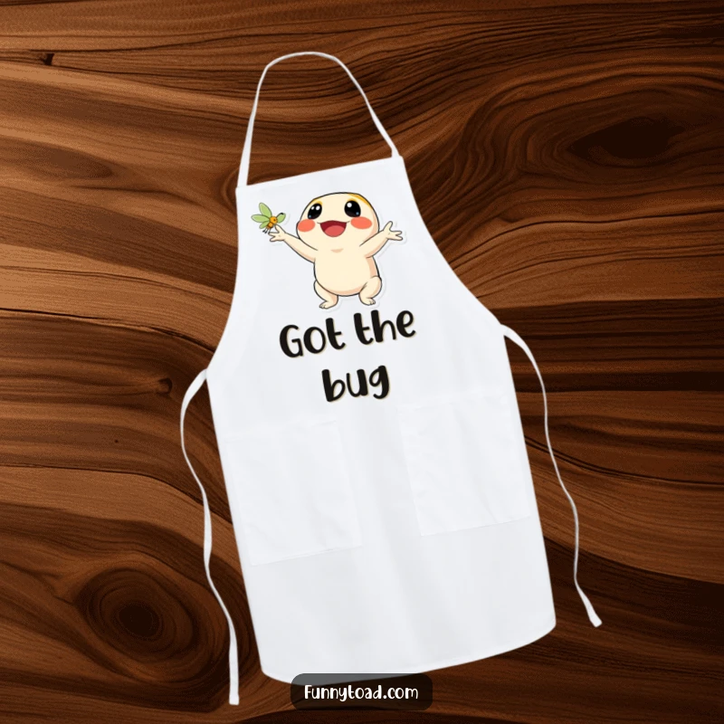 Funny apron showing a toad character’s wide, happy smile as it catches a fly. Humorous and practical kitchen wear.